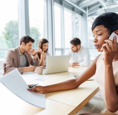 serious-businesswoman-with-documents-talking-on-P9Q6LX6@2x-402x391 (1)